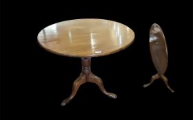 A 19th Century Mahogany Tilt Top Table of circular form, and turned supports on three cabriole legs.