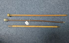 Three Military Officers' Swagger Sticks, two with round tops, one with a top depicting an animal