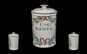 Apothecary Pot, with lid, measures 8'' tall. Decorated with flowers, and reads 'Ung Agrippae' to the