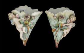 Pair of Victorian Wall Sconces, decorated with a cherub and floral design. Approx. 7.5" high.