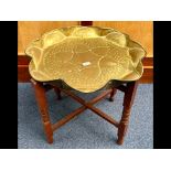 Brass Topped Moroccan Style Coffee Table, raised on wooden base, measures 22" diameter x 21" high,