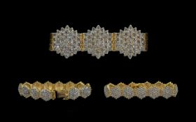 Ladies Modern 18ct Yellow Gold Diamond Cluster Set Bracelet, consisting of thirteen diamond clusters