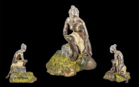 Cold Painted Bronze, finely detailed, depicts a woman collecting water in a jug, on a rocky base.