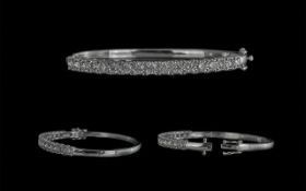9ct White Gold Hinged Bangle set with 2.21 ct Round Brilliant Cut diamonds, with double safety catch