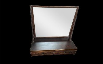 A Mahogany Regency Toilet Mirror, rectangular mirror above two drawers on rectangular supports.