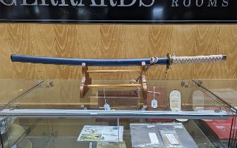 Replica Samurai Sword, with a woven handle, good details throughout, on wooden stand.