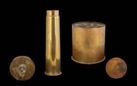 Three Brass Shell Cases, a tall brass 16" shell, and a 9" diameter x 9" high shell case, and a 5.
