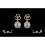 Pair of 9ct Yellow Gold Round Freshwater Pearl and Diamond Pinwheel Earrings, boxed. Diamonds 0.