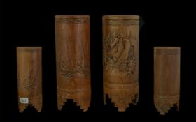 Two Oriental Carved Bamboo Vases, decorated with figures and ships, measure 10.5" tall.