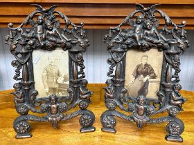 A Pair of Late Victorian Cast Metal Copper Patinated Easel Back Photo Frames with Cherub Finials,