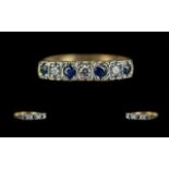 14ct Gold Attractive Seven Stone Diamond and Sapphire Set Ring. Marked 14ct to Shank. The Faceted