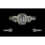 Platinum & Diamond Ring, set with an emerald cut centre stone with two round brilliant cut, fully