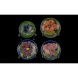 Moorcroft Collection comprising three 4.5'' pin dishes, Hibiscus pattern, Clematis pattern, and