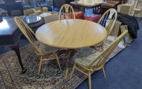 Blonde Ercol Elm & Beech Circular Table and Four Chairs, table diameter 48''. Four high back spindle