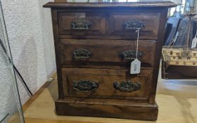 An Early 20th Century Oak Table Top Chest, two short over two long graduating drawers, raised on a