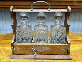 Tantalus 3 Cut Glass Bottle Set, In Wooden Holder with Key. Complete with Stoppers.