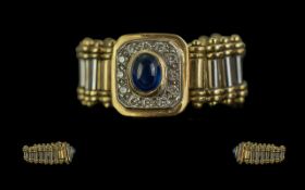 18ct White & Yellow Gold Sapphire & Diamond Set Link Ring, the central oval sapphire surrounded by