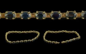 18ct Gold - Blue Sapphire Set Line Bracelet. Marked 750 - 18ct. Well Matched Blue Sapphires, Est