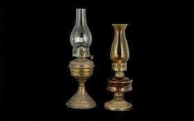 Two Vintage Oil Lamps, comprising a 17'' lamp on a brass base, and a Victorian pressed amber glass