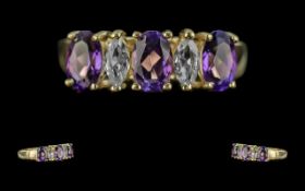 14ct Gold Attractive Amethyst and Sapphire Set Dress Ring. Marked 585 - 14ct to interior of shank.