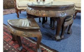 Dark Wood Circular Oriental Table with four integral stools, the top profusely carved with figures