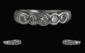Platinum & Diamond Eternity Ring, set with five brilliant cut diamonds in a rub over setting.