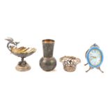 Swiss strut clock and three small white metal items