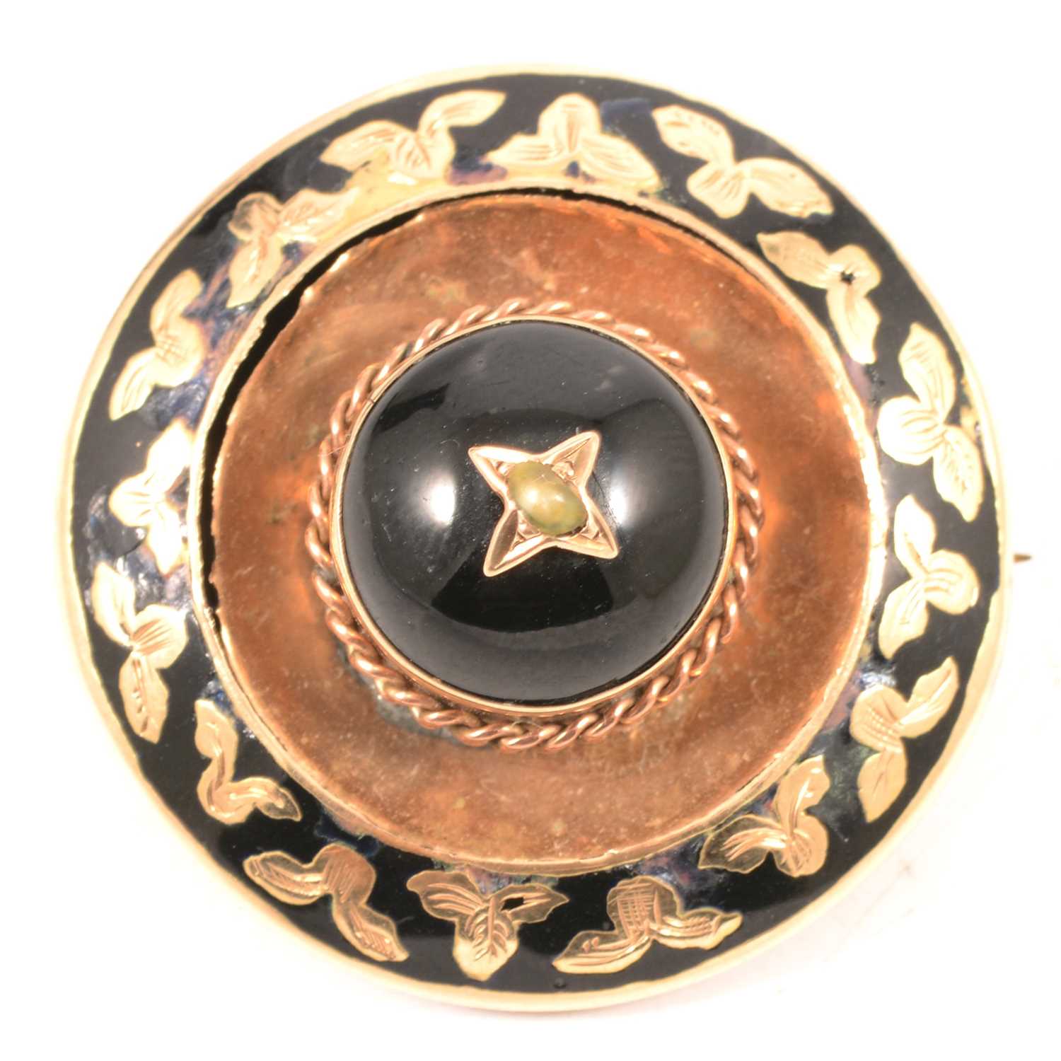 A circular yellow metal mourning brooch with locket back.