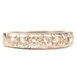 A diamond half eternity ring.