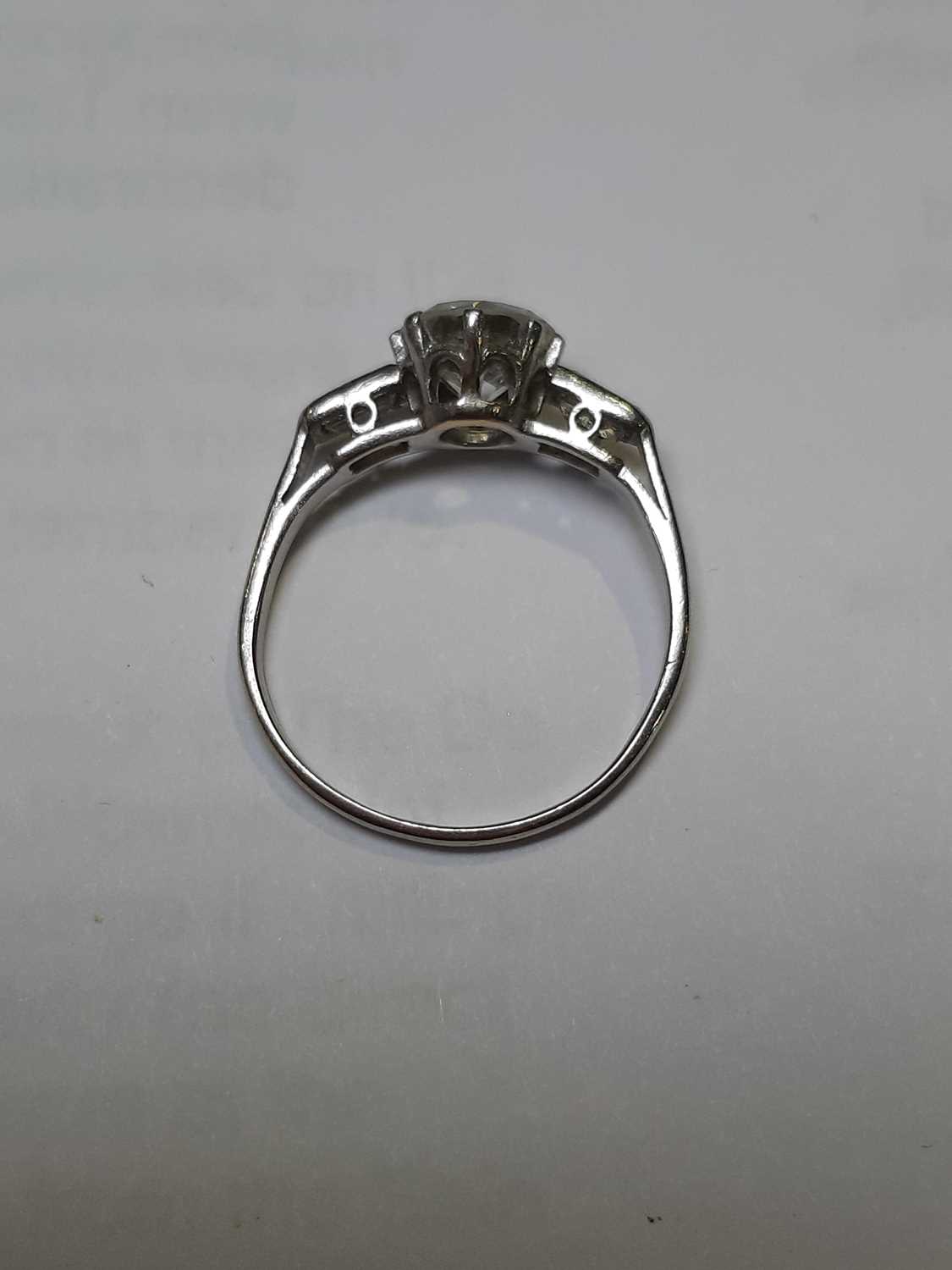 A diamond solitaire ring with baguette cut shoulders. - Image 6 of 7