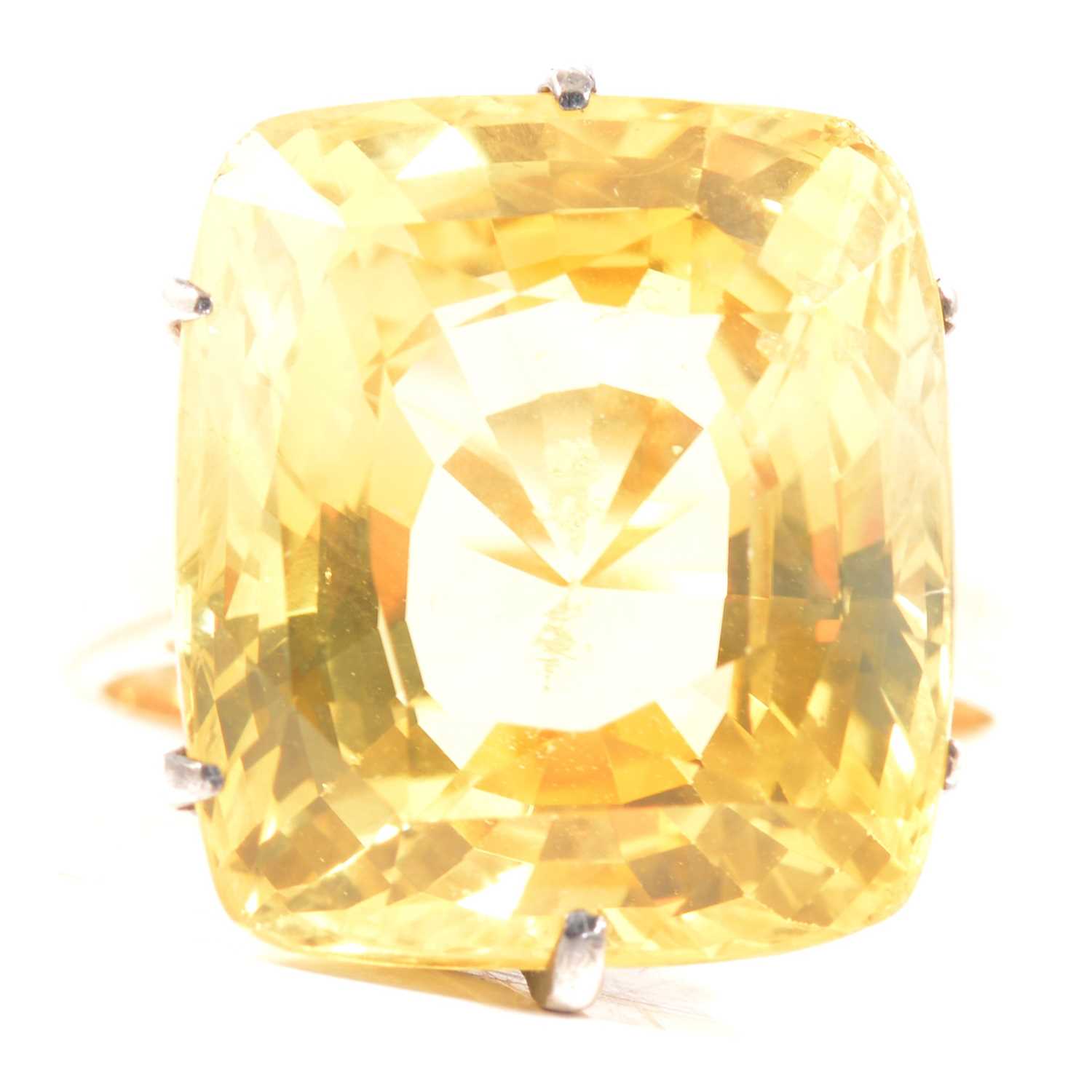 A large yellow sapphire solitaire ring.