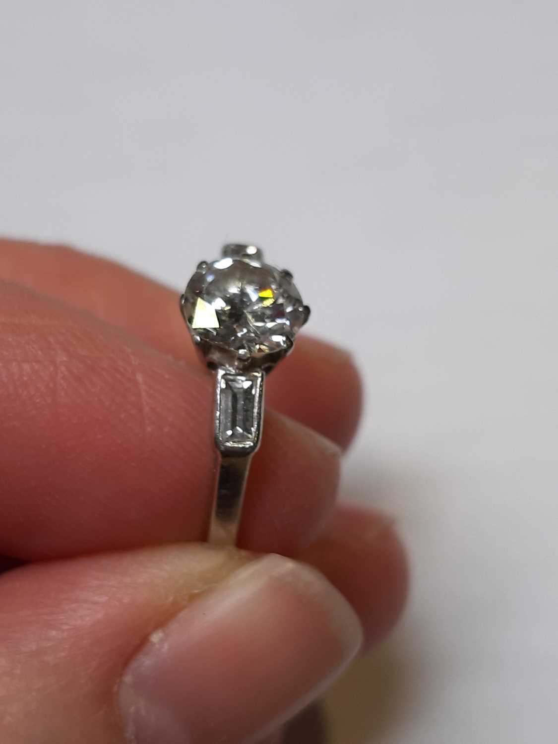 A diamond solitaire ring with baguette cut shoulders. - Image 3 of 7