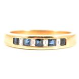 A sapphire and diamond half eternity ring.