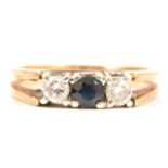 A sapphire and diamond three stone ring.