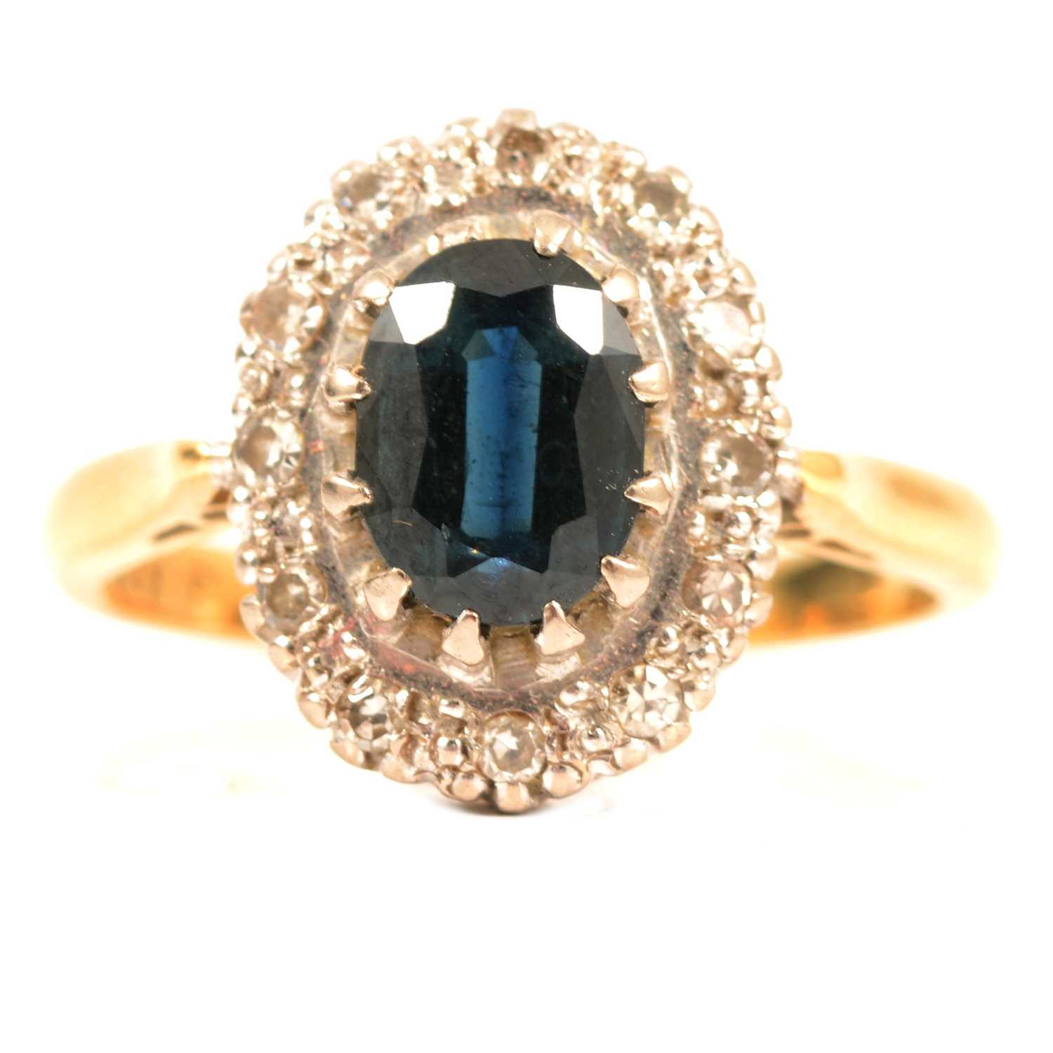 A sapphire and diamond oval cluster ring.