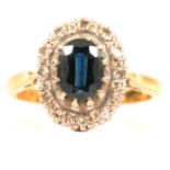 A sapphire and diamond oval cluster ring.