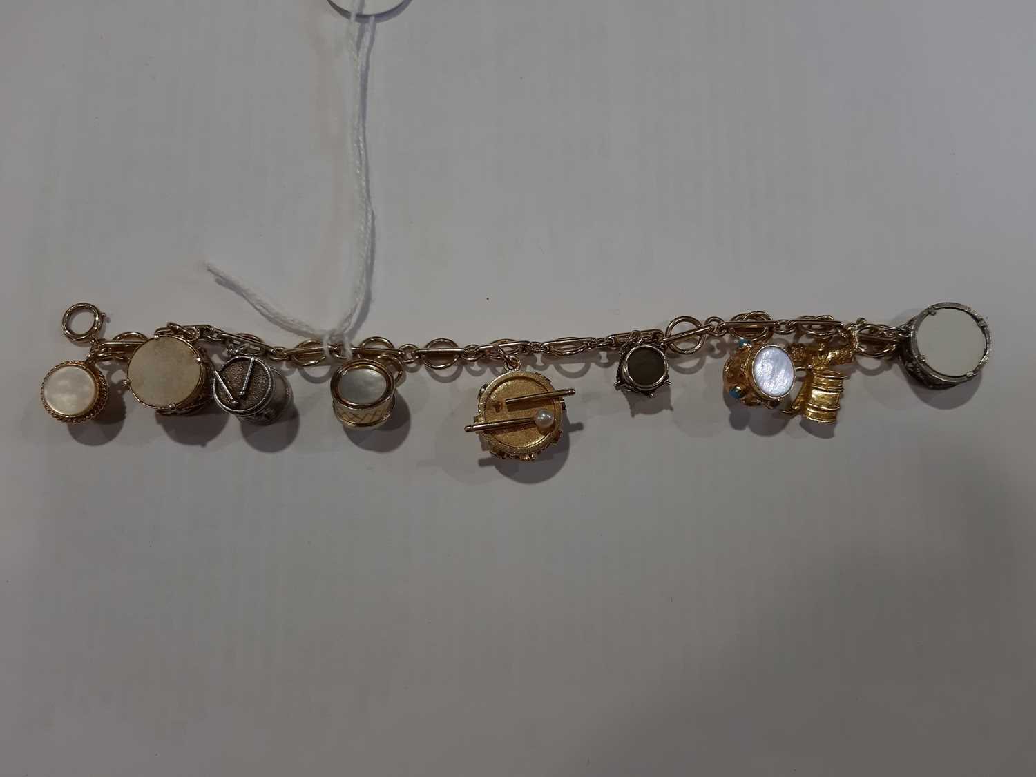 Two 9 carat yellow gold charm bracelets with charms of mixed metals and standards. - Image 5 of 7
