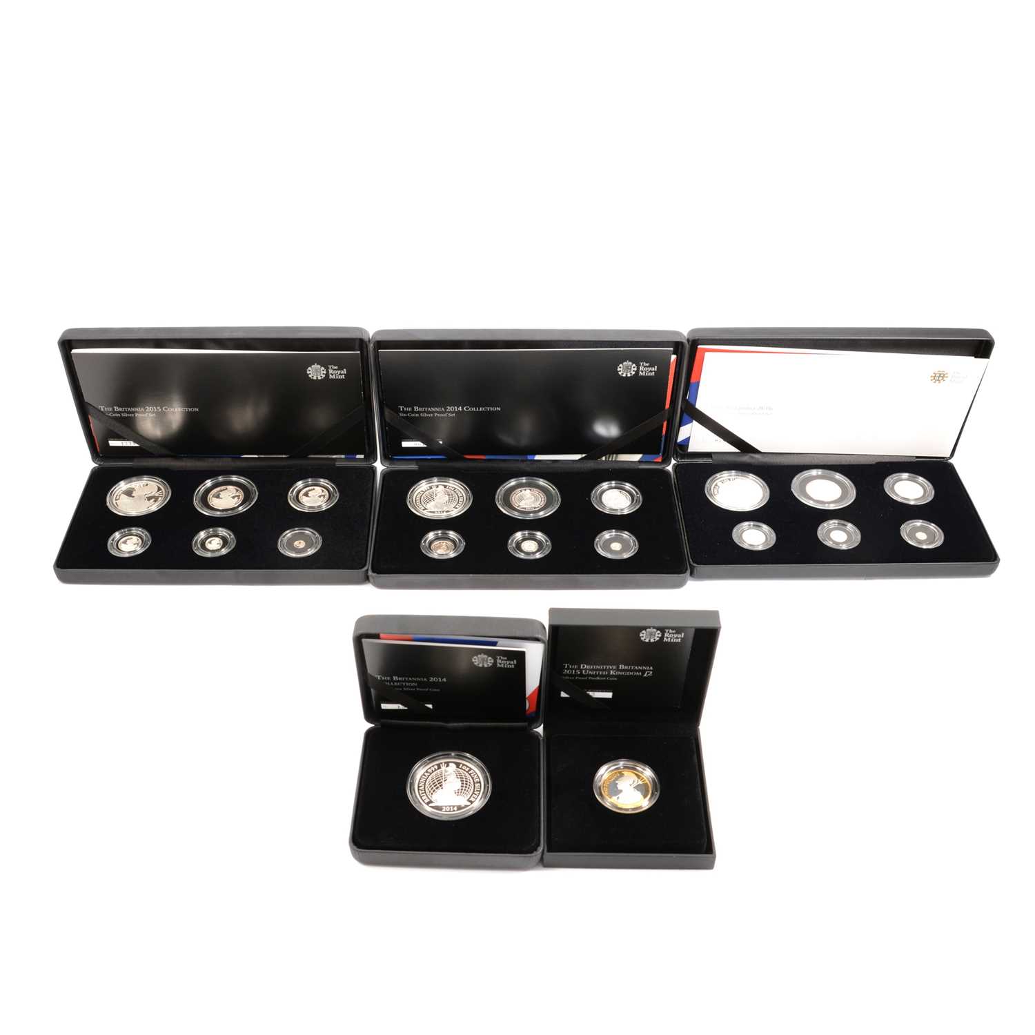 Five Royal Mint commemorative coin sets