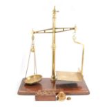 Pair of large brass balance scales, with weights, by W. & T. Avery Ld etc