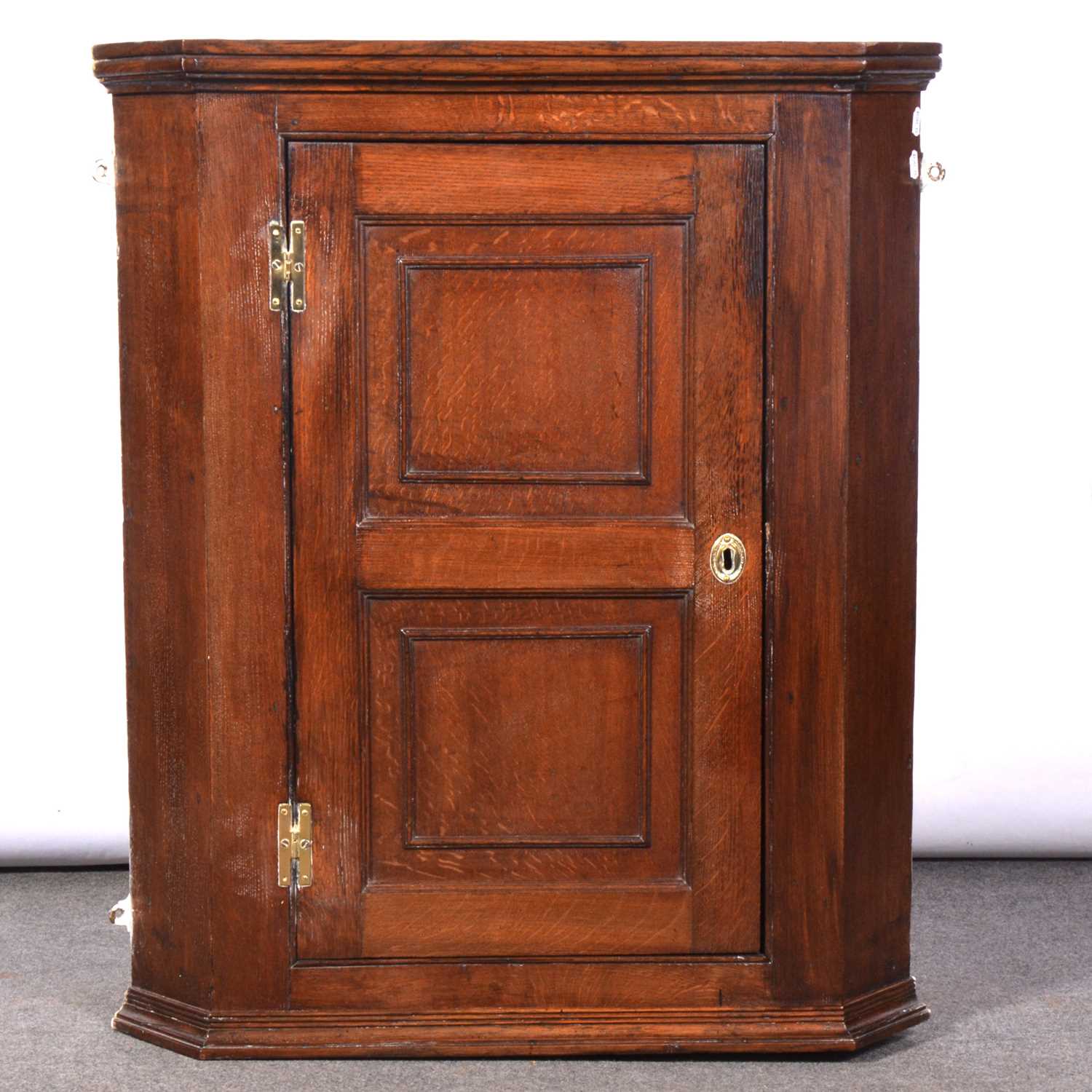 George III oak hanging corner cupboard,