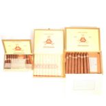 Three open boxes of Montecristo cigars