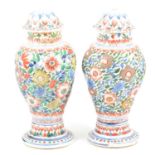 Pair of Chinese porcelain covered vases, clobbered decoration