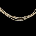 A four strand fine seed pearl necklace with hair locket clasp.