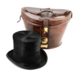 An early 20th century black silk top hat, by G A Dunn & Co, in a leather case