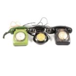 Five vintage telephones, one green.