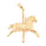 A 9 carat yellow gold carousel horse pendant.