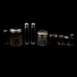 Four large silver-topped glass jars, other silver jars and bottles.