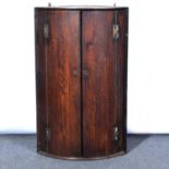 George III oak bowfront hanging corner cupboard,