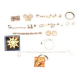 Silver charm bracelet with gold and silver charms, bangles, bracelets, cufflinks, rings, and coins.