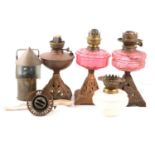 Three oil lamp bases, a carbide miners lamp, and spare parts